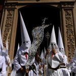 The colours of the robes worn by penitents depend on which brotherhood they belong to. Here, members of the Borriquita brotherhood parade during celebrations marking the feast of Palm Sunday in Seville on March 29th. Photo: Cristina Quicler/AFP