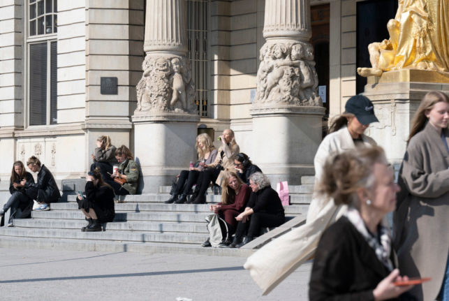 people soaking up the sun on the steps of Dramaten in Stockholm