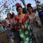 Women walk through the streets in the traditional flamenco-style dresses.Photo: Cristina Quicler / AFP.