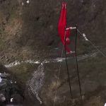Norway man in ‘human flag’ stunt over waterfall