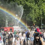 Firefighters douse the crowd with cool water, making a - very apt - rainbow appear. Photo: Calvin Smith/Flickr