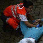 Medical services attend to a man who was injured during the last "encierro" (bull-run) of this year's San Fermin Festival in Pamplona. Photo: Miguel Riopa/AFP