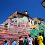 A group of tourists admire the artwork painted on the facade of a Fanzara house.Photo: Jose Jordan / AFP