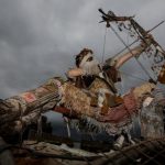 A festival-goer dressed as a warrior of the apocalypse aims an arrow at the sky.Photo: Photo: DPA