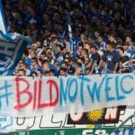 Football fans show anger at Bild over refugees