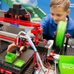 A child plays with a 3-D printer made from a modular design. This  gadget comes from Fischertechnik.Photo: Photo: DPA
