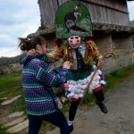 <b>Maceda, Galicia.</b> A villager dressed as a "Felo" jokes with a woman during the traditional and ancestral carnival.The Felos are the "authority" during the week of Carnival, meaning they can break the rules. The mask represents virility. Photo: Miguel Riopa/AFP.