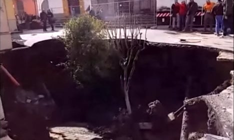 Huge sinkhole swallows car and trees in Italian square
