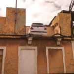 Police baffled by car parked on top of house in Spain