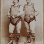 Two muscular men show off their studded outfits.Photo: Wien Museum