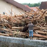 A resident of Simbach am Inn, Bavaria, photographs a pile of wood dumped by the flooding.Photo: DPA
