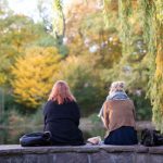 Two women enjoy the fall foliage in a park in Hamburg.Photo: DPA