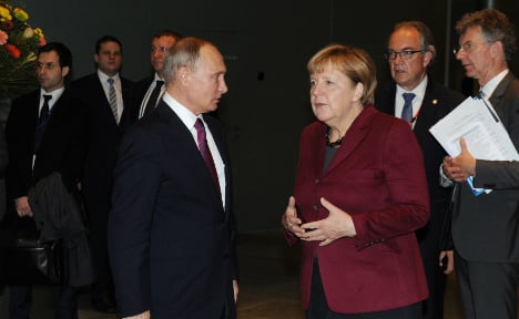 Merkel threatens Putin with more sanctions on Berlin visit