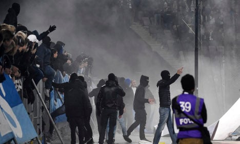 Fans throw flares and enter pitch in Swedish football riot