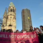 Refugees, Berliners sing together against hate at attack site