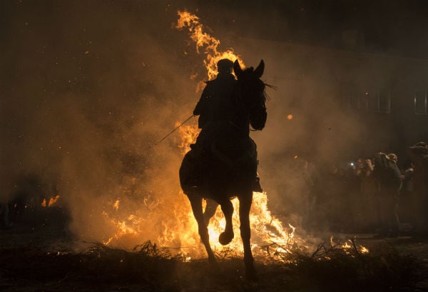 GALLERY: Holy Smoke! Horsemen gallop through flames at Spanish fiesta