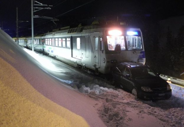 Train smashes into car in snow on Swiss railway line