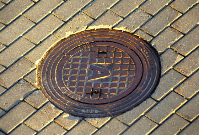 a manhole cover with the letter A