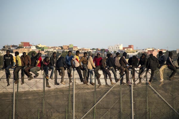 Hundreds of migrants storm fence to enter Spain from Morocco