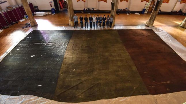 Tennis court-sized French flag unfurled at UK castle