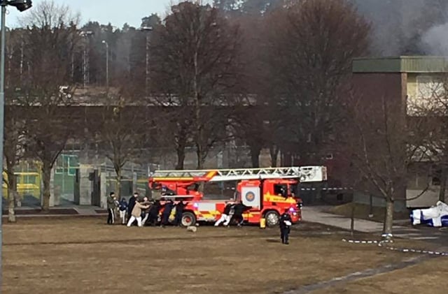 Viral photo of locals helping firefighters 'shows positive side' of Stockholm suburb