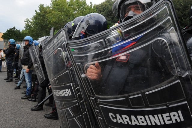 Police officers injured in clashes outside Italy G7 meet