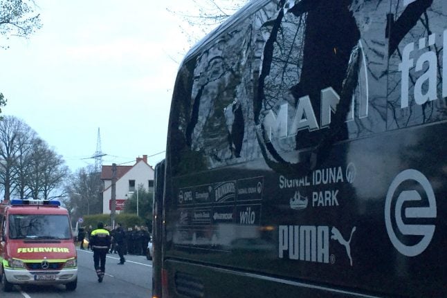 Police search for clues after explosions near Dortmund team bus injure player