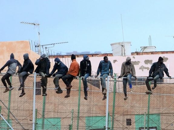 Migrants storm border fence from Morocco into Spain