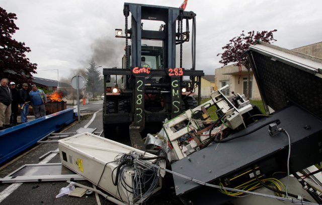 Angry French workers booby-trap factory, trash machines and threaten to blow the place up
