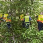 Walker discovers charred body in woods