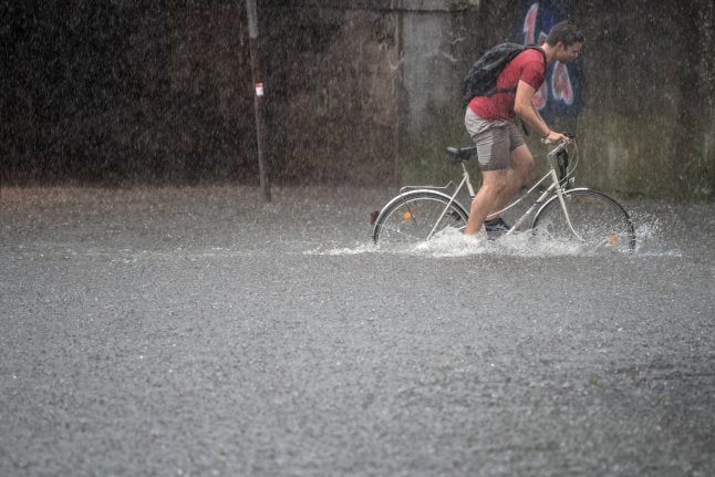 Heavy storms flood streets, kill one in west Germany