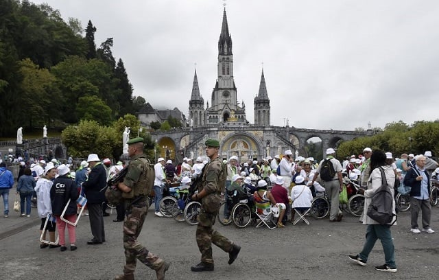 Catholic pilgrims celebrate Assumption in Lourdes under tight security
