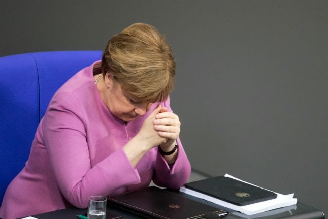 Wounded and weakened, Merkel starts coalition talks with awkward partners