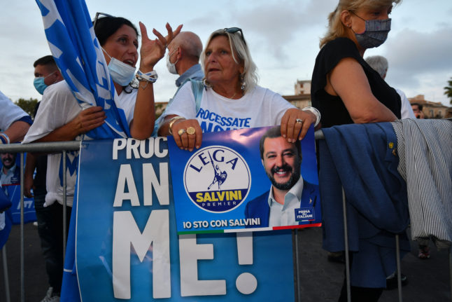 A woman holds a League poster during a rally of the party in Catania, Sicily, on October 2, 2020.