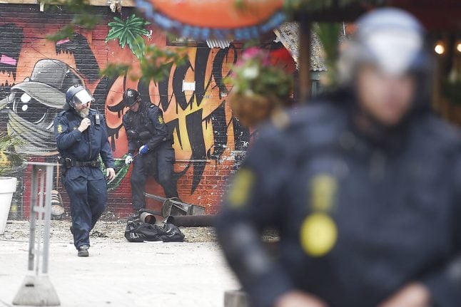 Danish police arrest 13 in tense Christiania raid