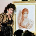 With a picture of a self portrait she donated to auction in 1999Photo: Amr Nabil/AFP