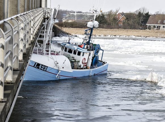 Fishing boat gets stuck in Danish ice, collides with bridge