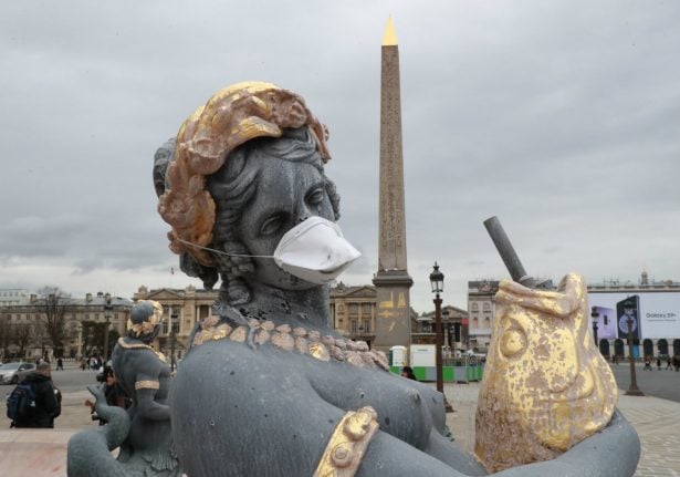 French statues get anti-pollution masks in clean air protest