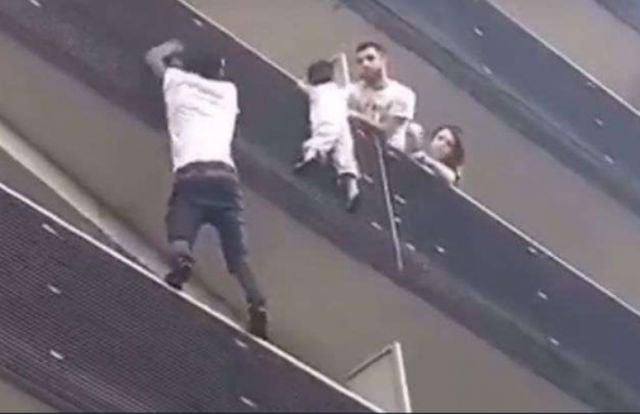 VIDEO: Paris 'spiderman' scales building to rescue dangling toddler