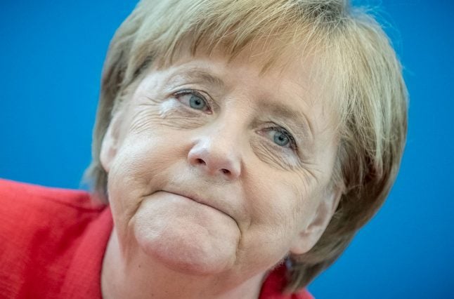 Merkel party slumps in polls as dispute on refugees threatens split