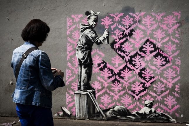 Banksy takes aim at French government with migrant mural blitz in Paris