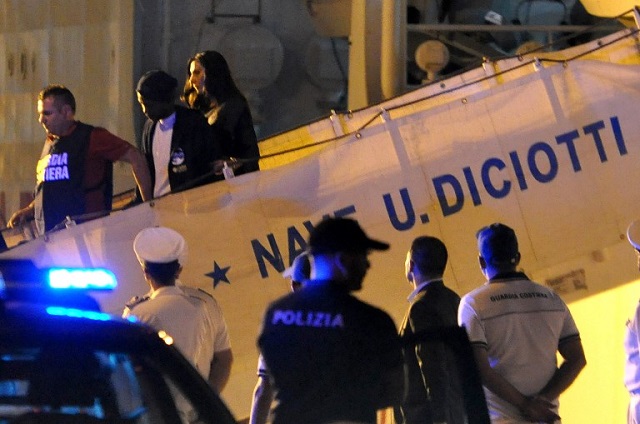 Migrants disembark coast guard ship in Sicily after reports of violence