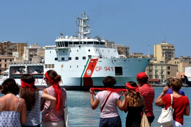Italy's interior minister refuses to let migrants on coastguard ship disembark