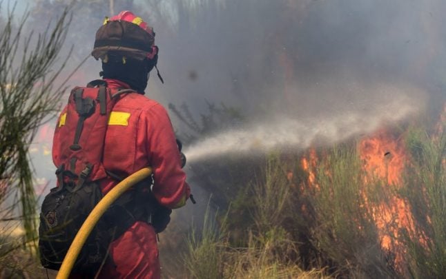 Firefighters battle wildfire threatening natural park in southern Spain