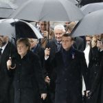 Merkel joins Trump and Putin in sombre Paris ceremony