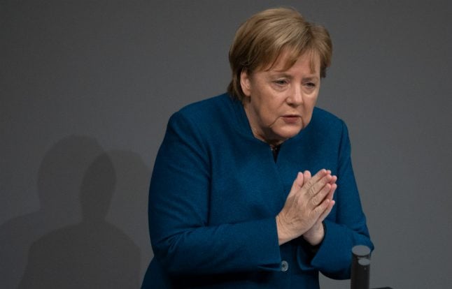 Merkel defends UN migration pact amid party split on issue
