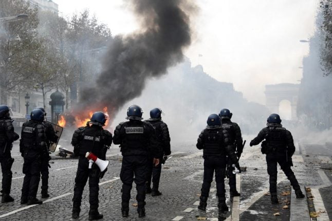 IN IMAGES: Burning barricades, tear gas and water cannon – The battle of the Champs-Elysées