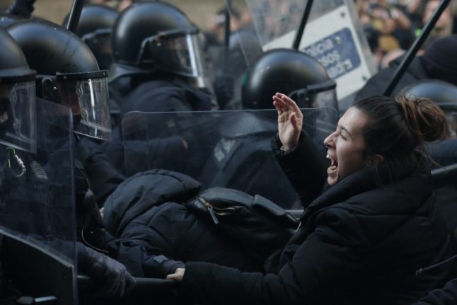 Protestors clash with police and block roads in Catalonia