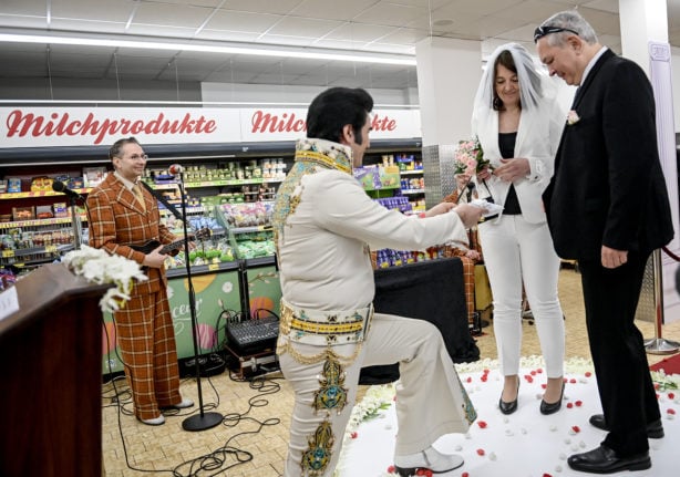 Leo and Carola put on their rings at their symbolic wedding ceremony in a branch of the Penny supermarket chain in the Berlin district of Wedding, February 22nd, 2022.