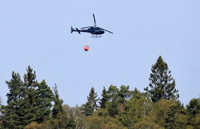 Helicopters water bomb wildfire outside Stockholm